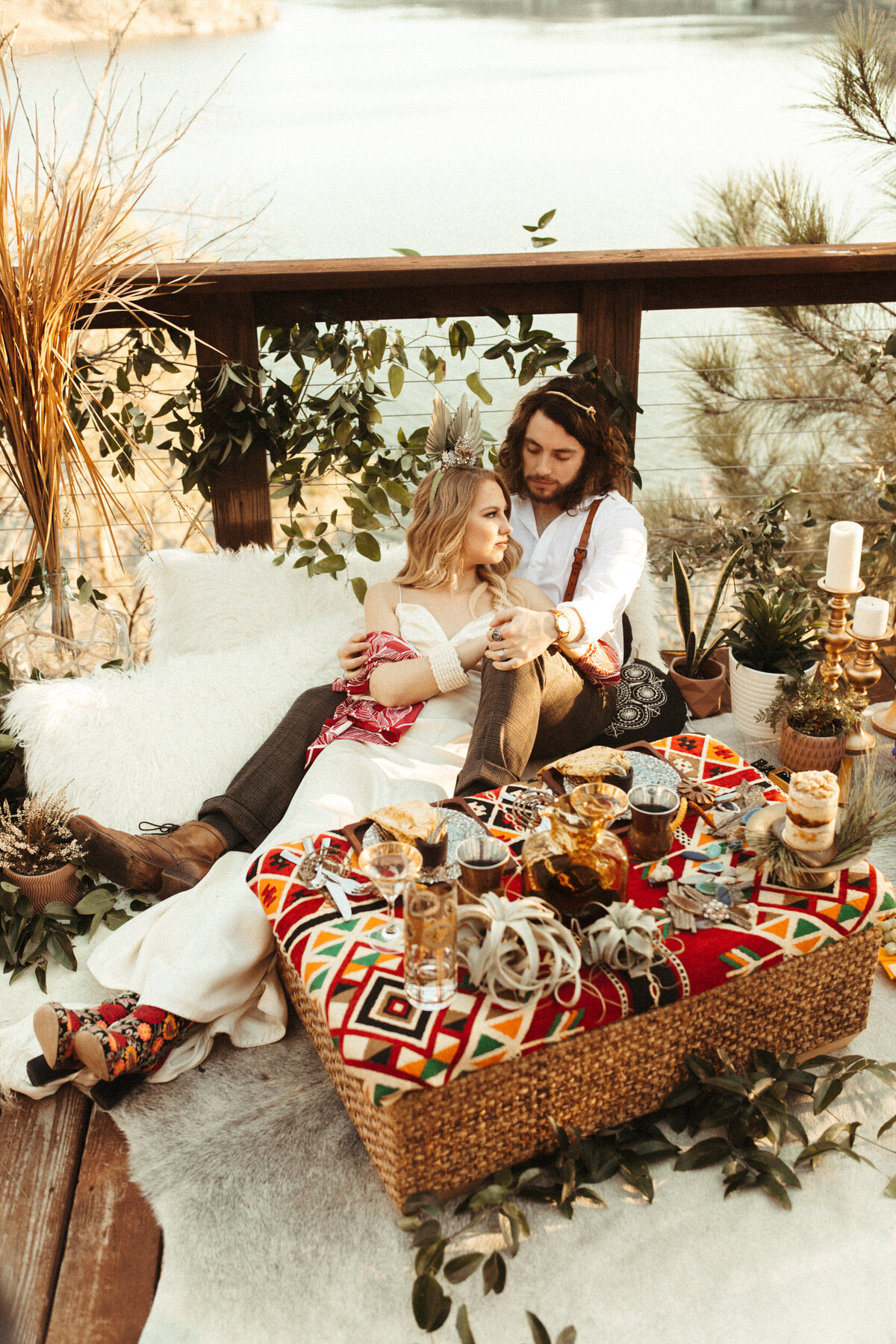 Boho bride and groom enjoying their elopement reception at the lake