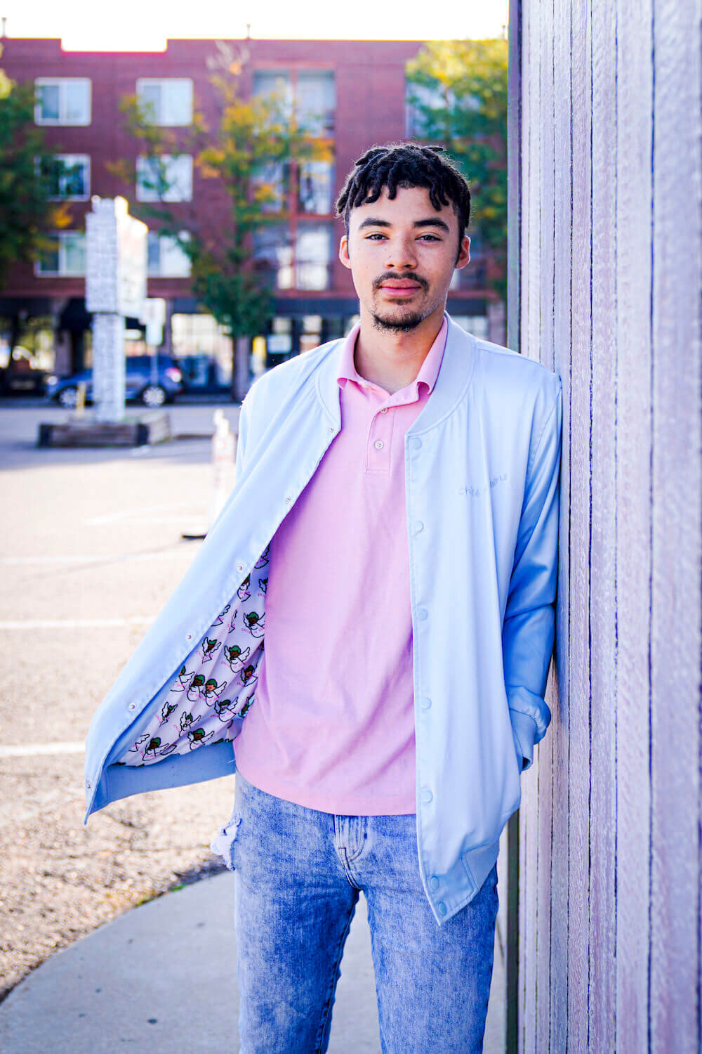 denver photography senior pictures - guy standing against wall