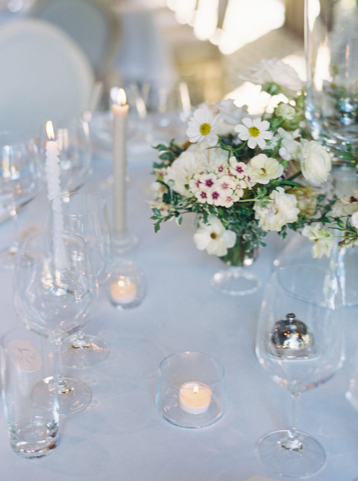 Elegant and timeless floral design for wedding reception tables. Wedding dinner at The Barn on Blackberry Farm. Garden inspired growing floral in colors of cream, white, blush, and green. Whimsical floral design for low centerpieces and elevated arrangements at fall wedding reception. Romantic candlelight and timeless floral design for elegant tablescapes. Destination wedding at Blackberry Farm. Design by Rosemary & Finch Floral Design in Nashville, TN.
