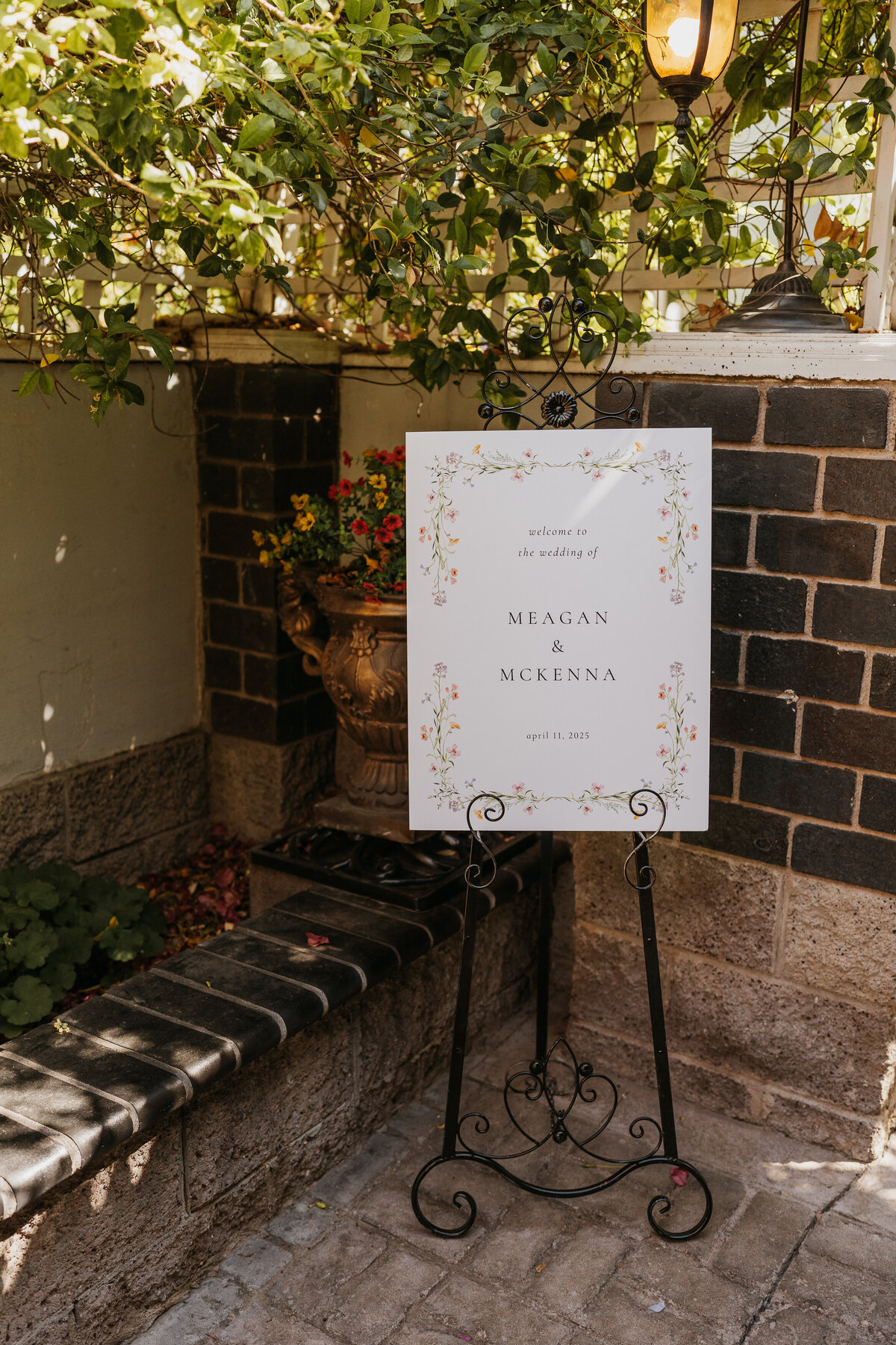 A sign set up in the corner of a garden announcing a wedding 