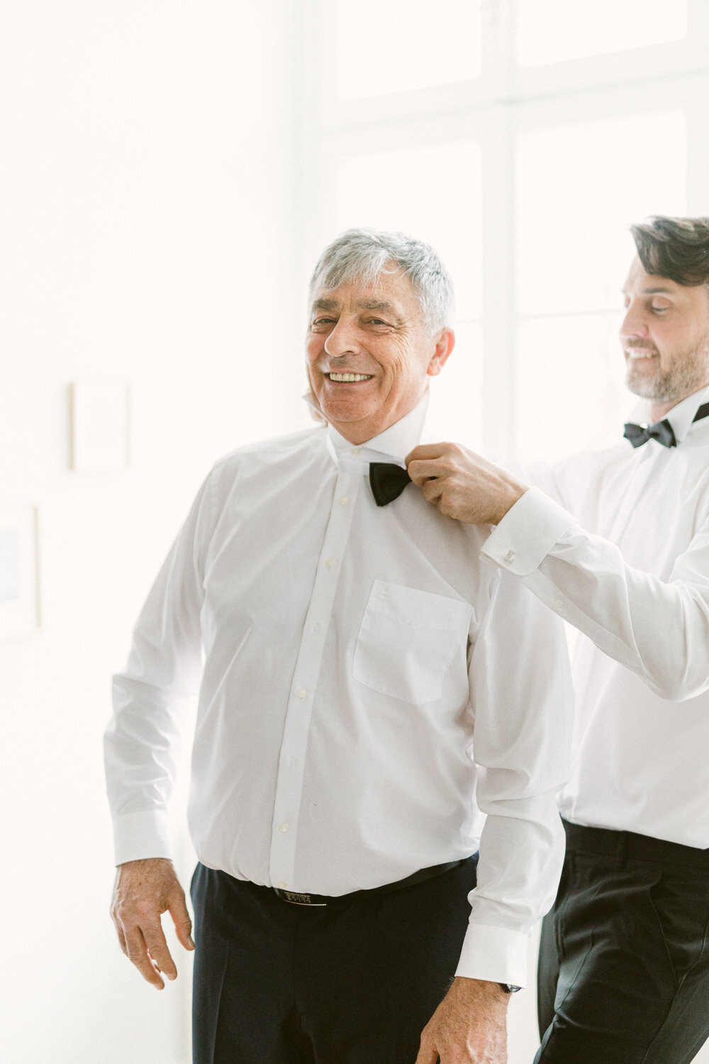 groom with his father during getting ready