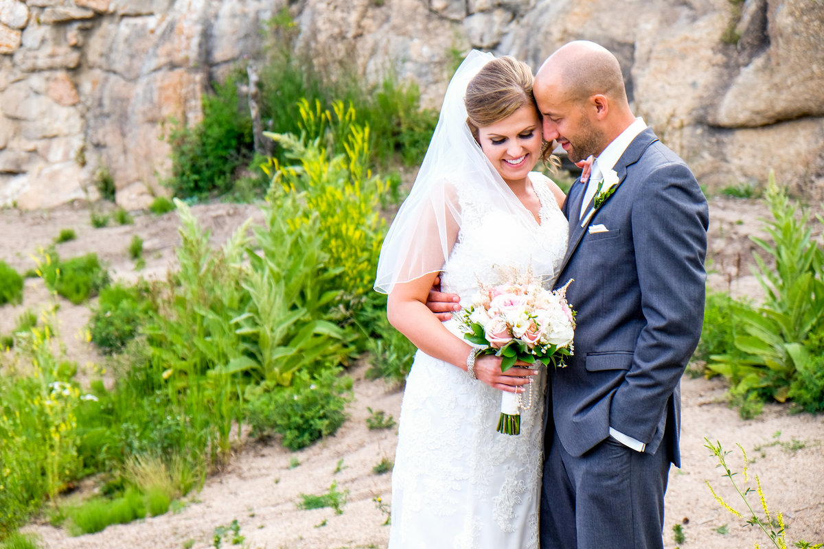 bride and groom near rocky mountains