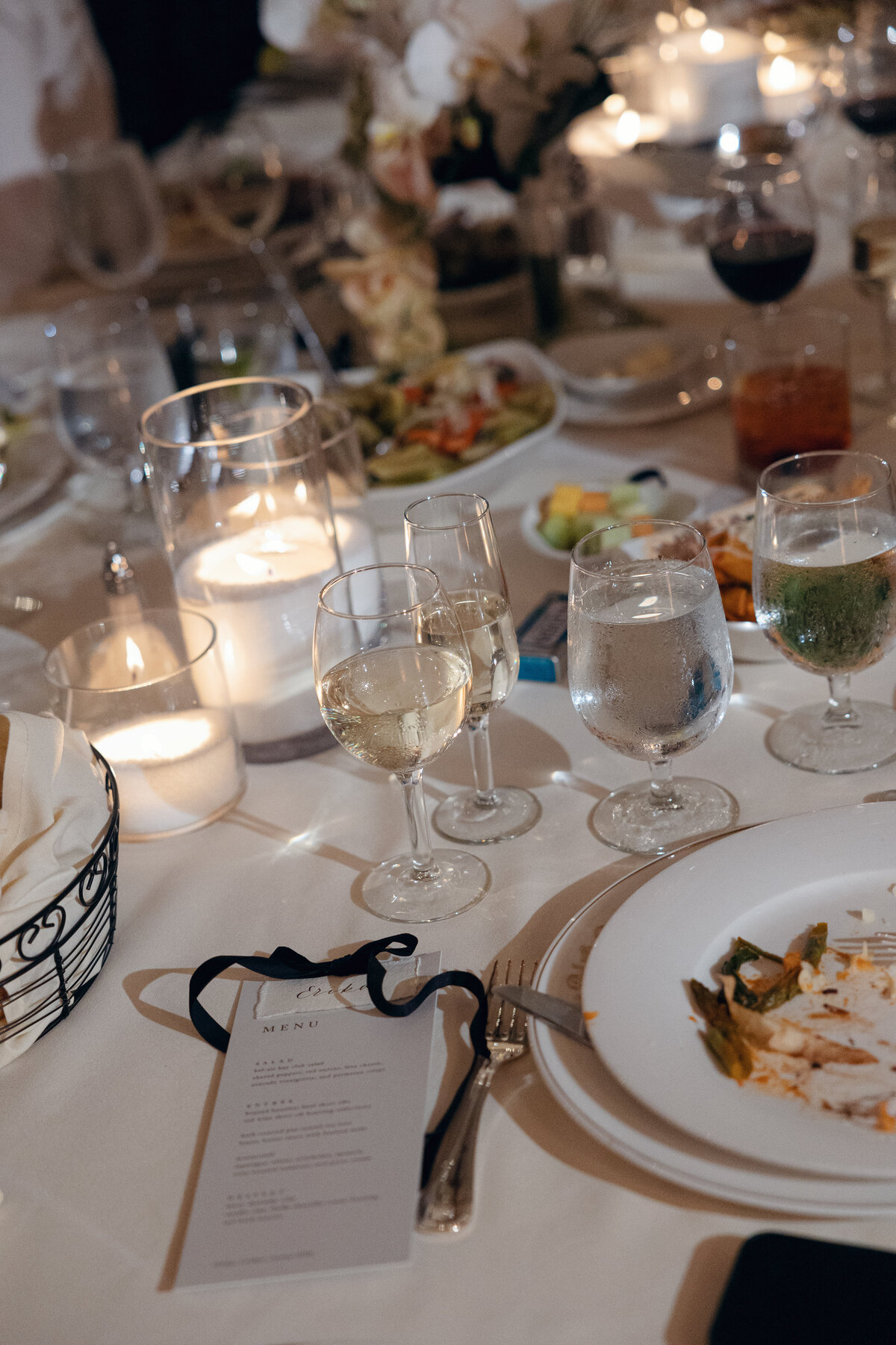 Reception decor with twinkling lights and elegant centerpieces, transforming the La Jolla wedding venue in California into a magical setting.
