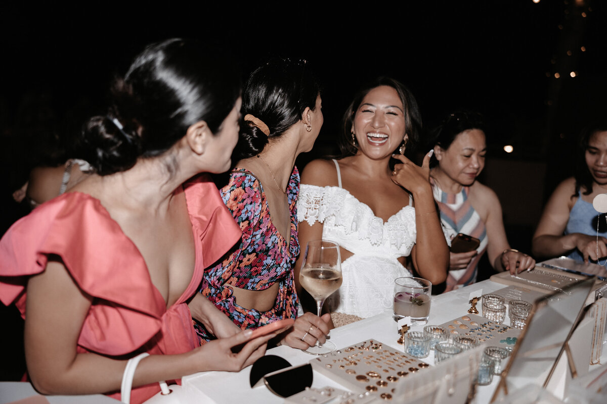 Girls standing in front of jewelry counter laughing