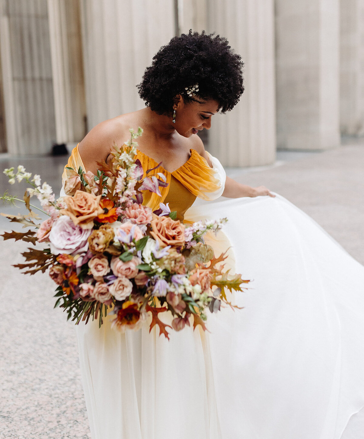 Beautiful autumnal bridal bouquet composed of roses, ranunculus, delphinium, clematis, lisianthus, and fall foliage floral hues of burnt orange, mauve, dusty rose, taupe, and lavender. Design by Rosemary and Finch in Nashville, TN.