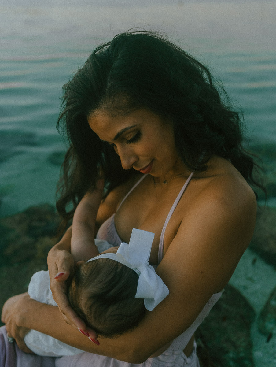 mother with daughter in water at family photoshoot