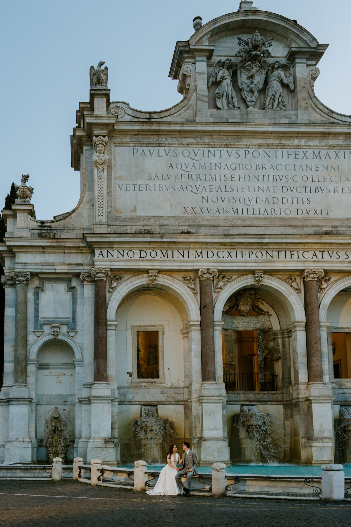Bride and groom in cozy Roman alley looking at each other.