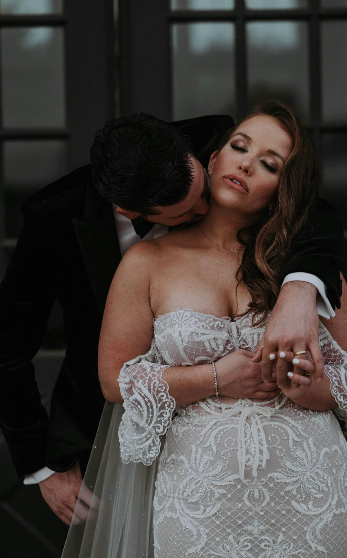 This romantic bridal look features glamorous smoky eye makeup and loose, side-swept curls. Mistique Makeup's San Antonio and Dallas salons offer full wedding hair and makeup services, including gel nails and french manicures for a polished finish.
