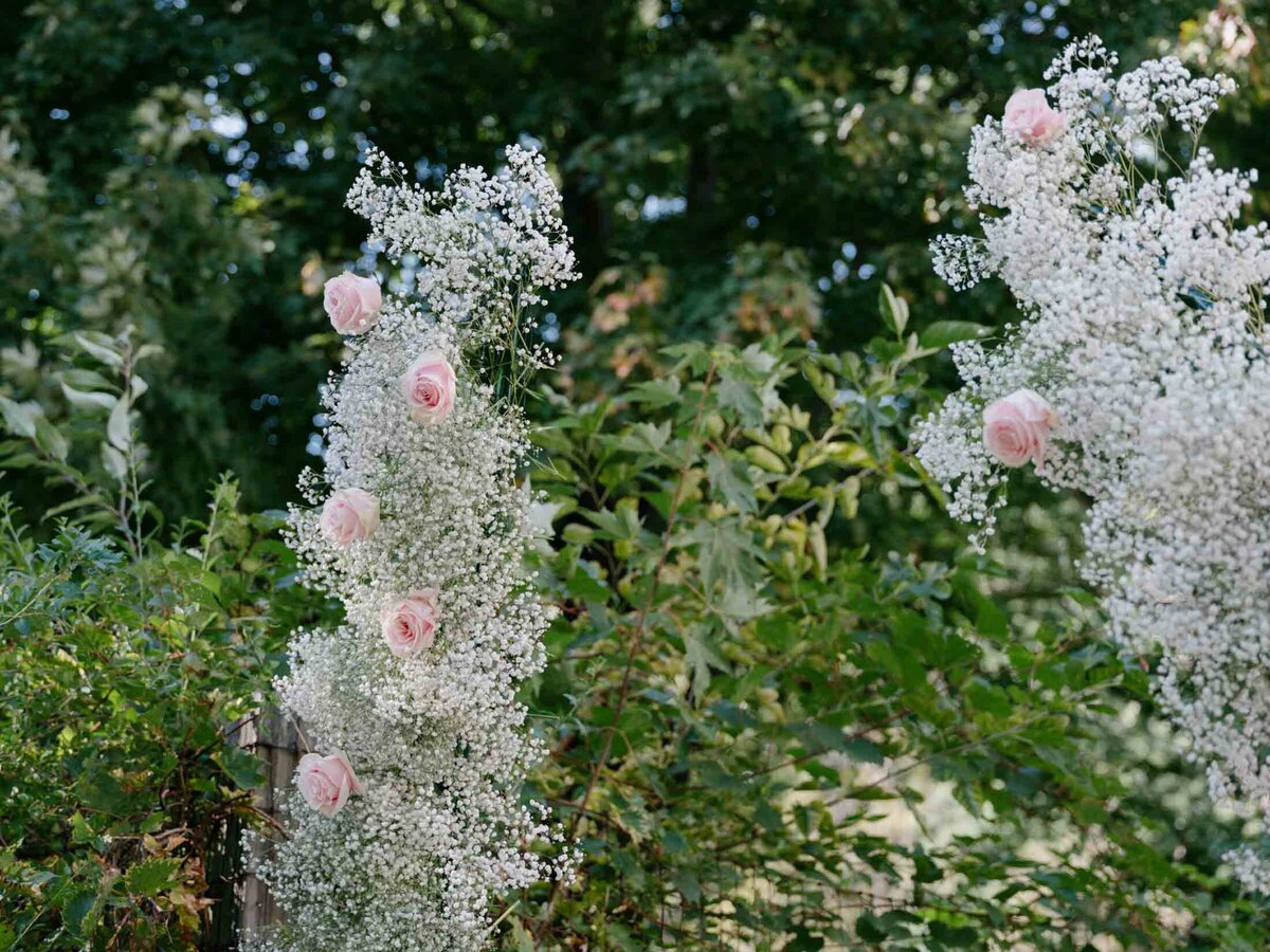 Pink roses in babies breath for wedding decor.
