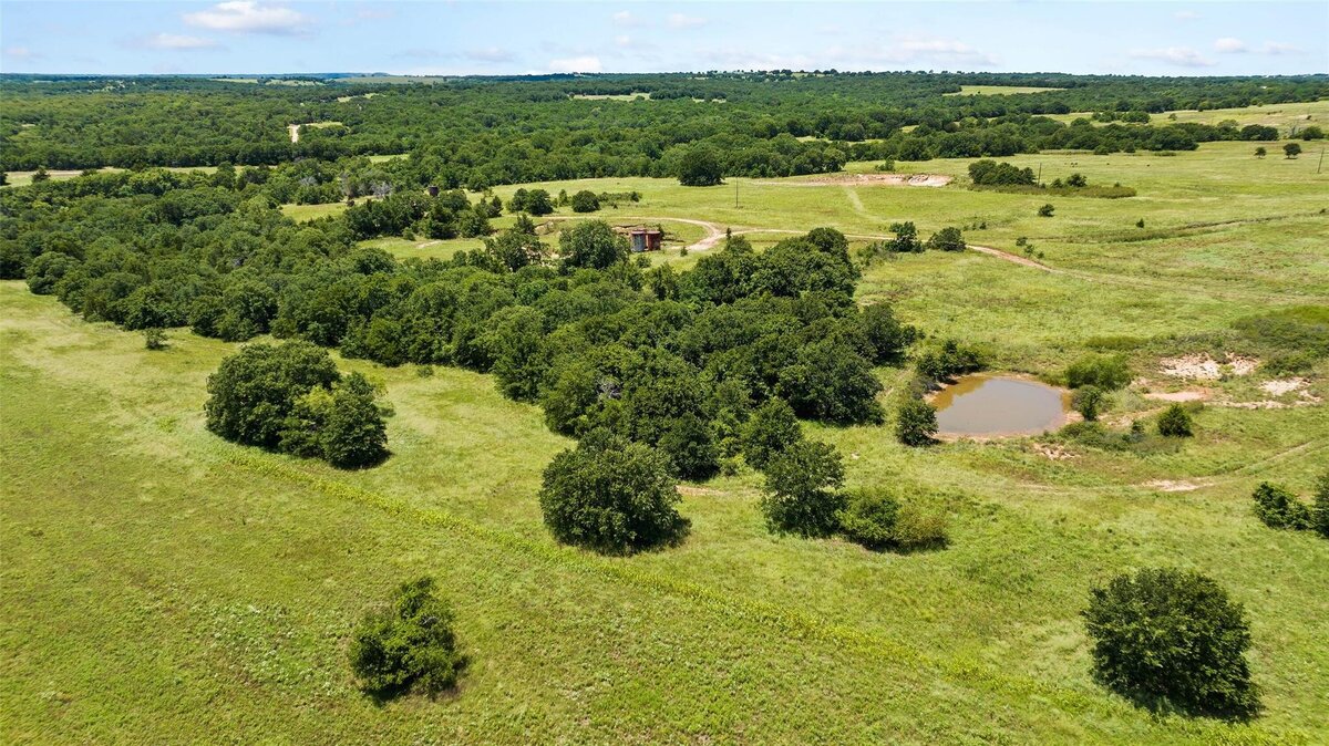 Aerial view of 55-acre property with mature post oaks in Saint Jo, TX