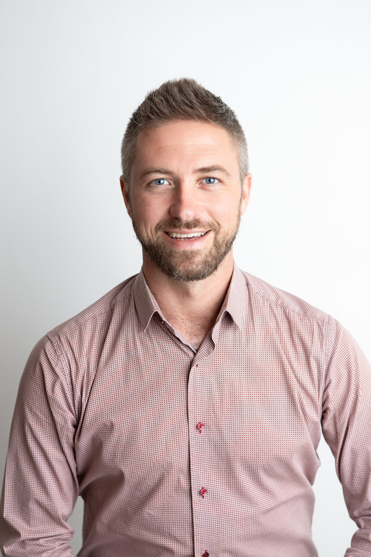 Studio headshot with plain white background