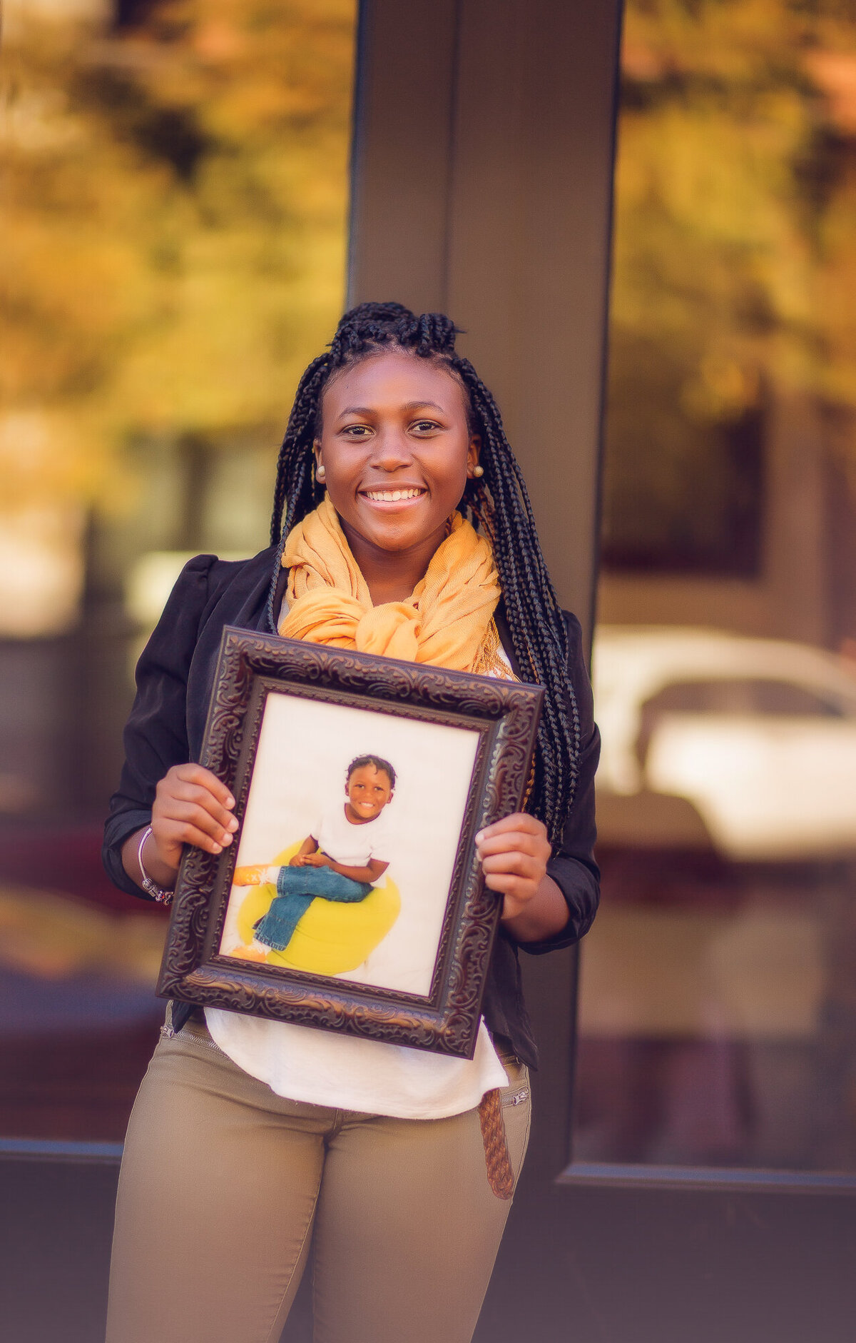 Color image of girl holding an image of herself
