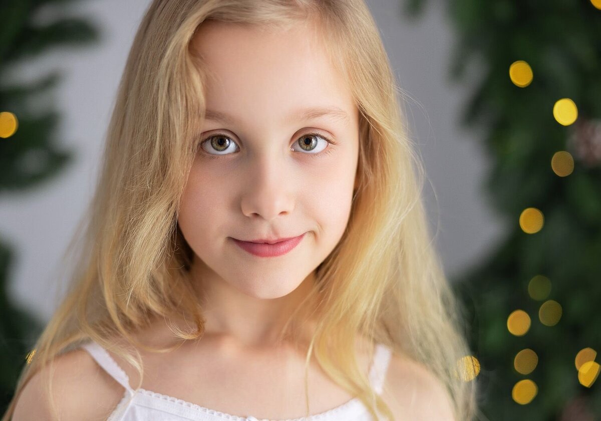 Image of a girl on a Christmas backdrop in the studio. Taken by Norwich portrait photographer Claire Howes. Christmas Mini Sessions Norwich.