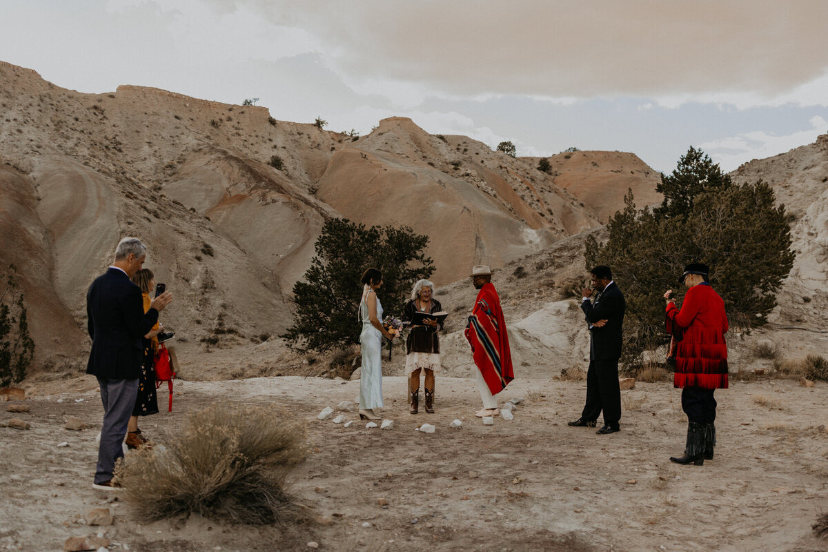 elopement ceremony with just the couple and their parents among beautiful rock formations in New Mexico