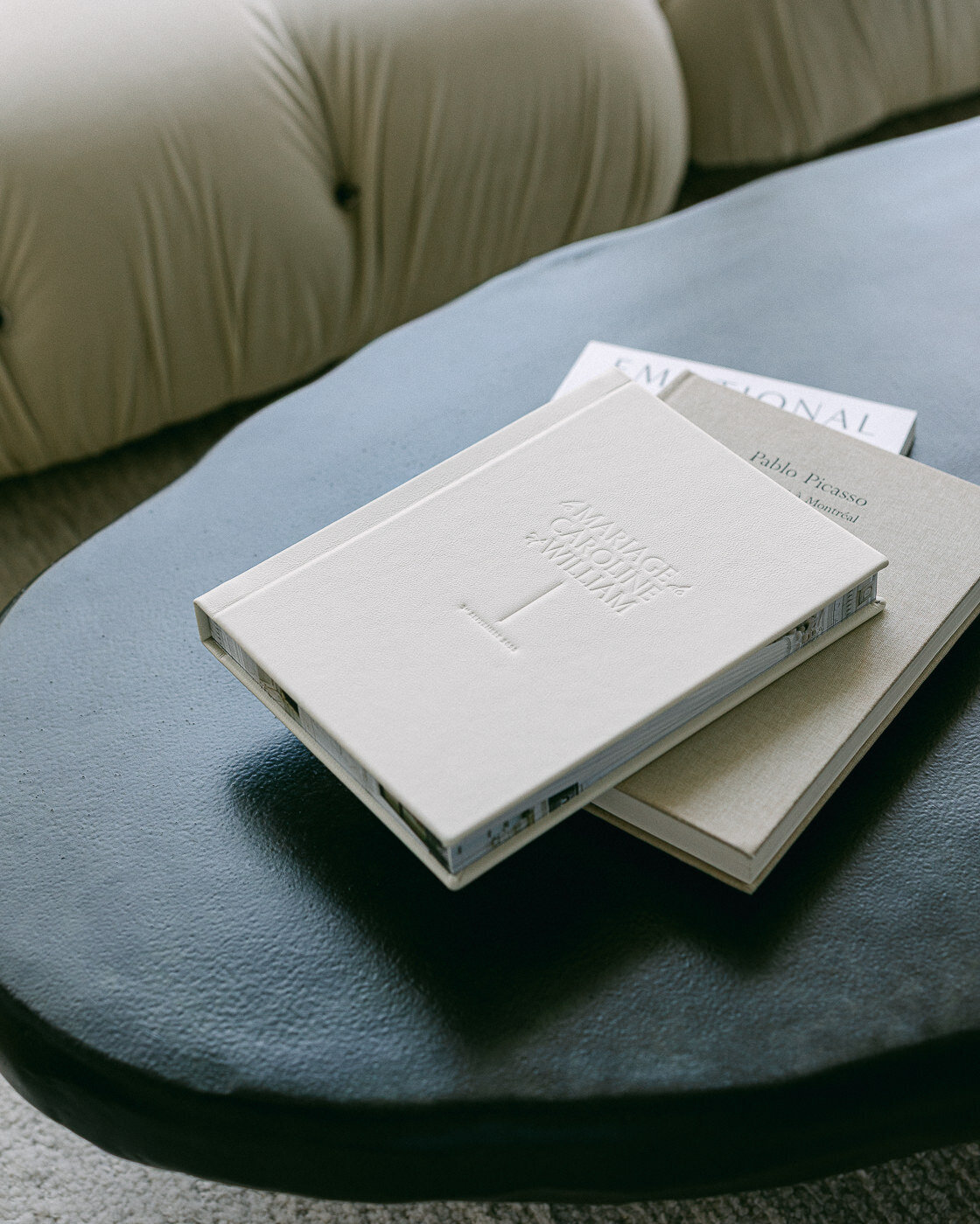 Un album photo de mariage déposé sur une table dans un salon moderne.