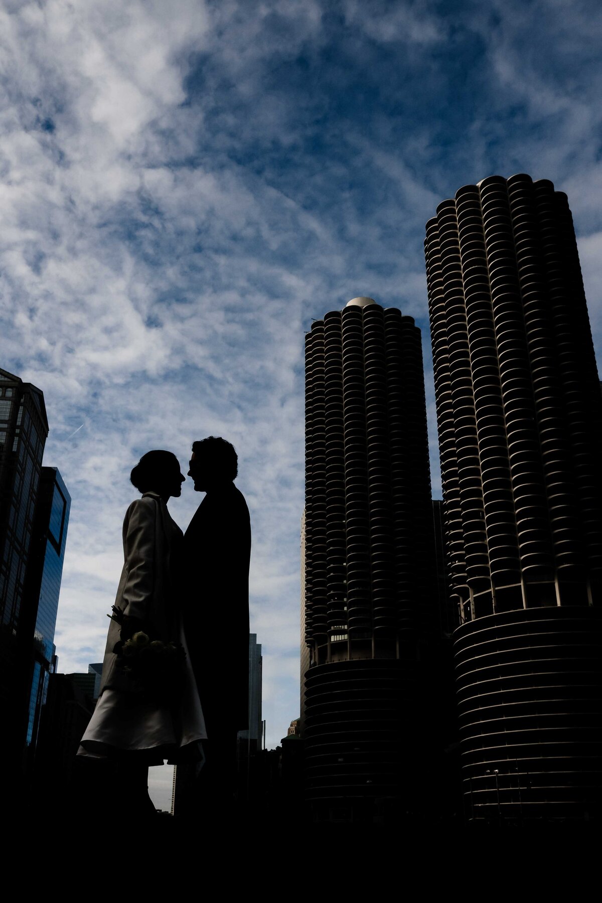 Couple stand on a bridge in Chicago.