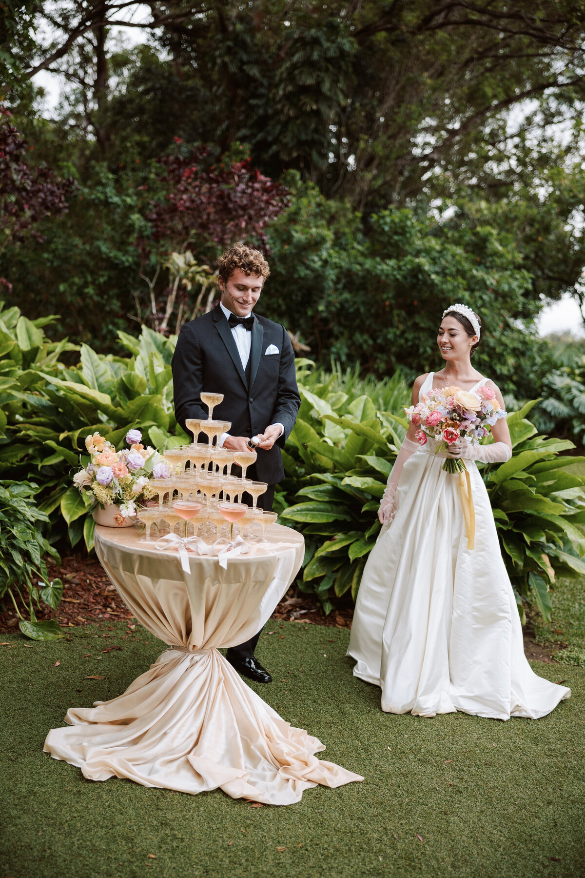Candid wedding moment of champagne popping, as the couple celebrates with guests.
