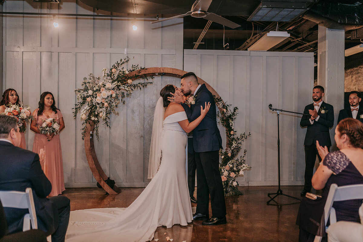 Couples kiss at the wedding altar