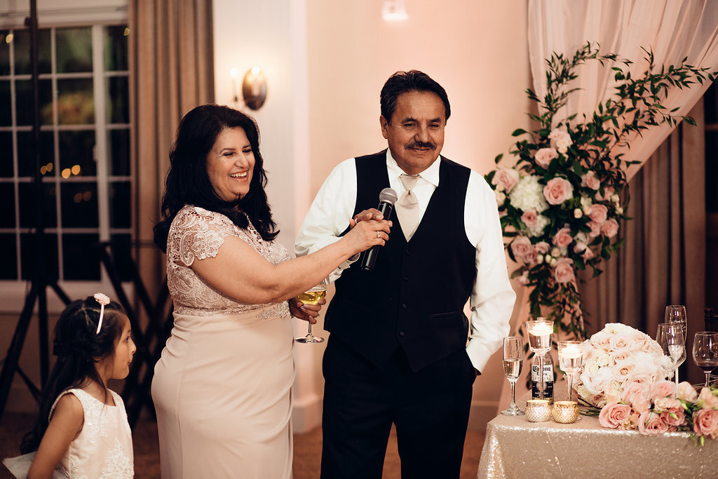 Wedding Photograph Of Woman In Light Brown Dress Holding The Microphone For Man In Black Suit Los Angeles