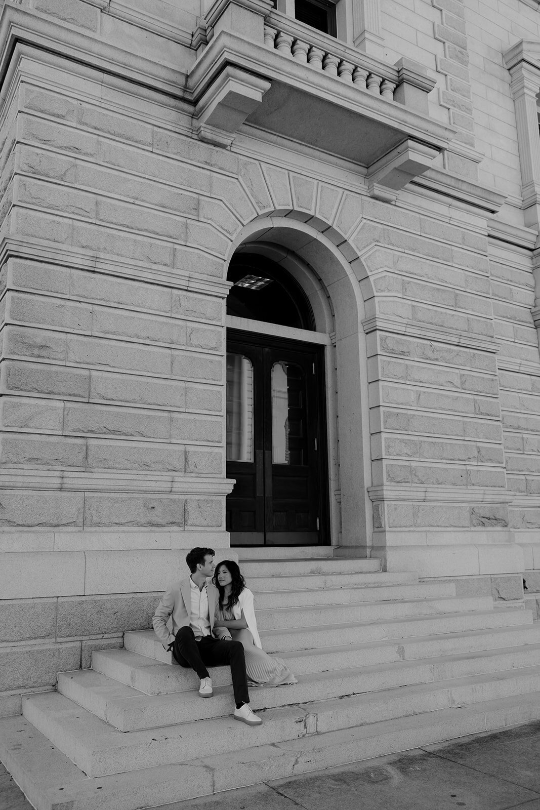 Couple sitting on stairs at Postal Museum in Charleston