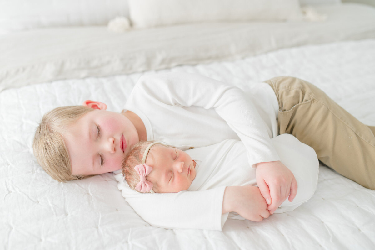 baby-girl-snuggling-with-big-brother