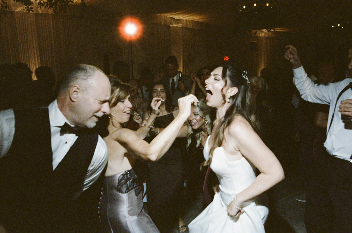 35mm film wedding photo of bride having a great time on the dance floor at Boscobel House & Gardens