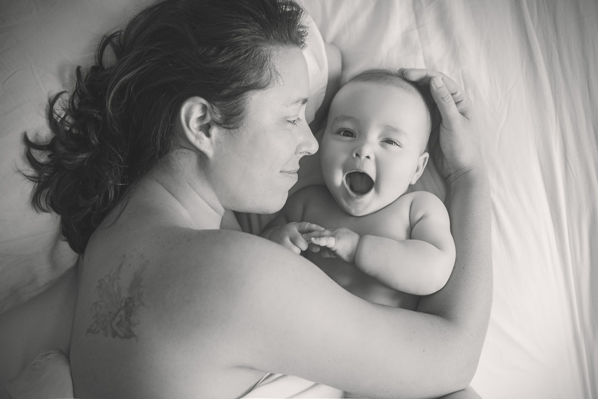 charlotte documentary photographer jamie lucido captures a lifestyle image of a mother and baby in bed