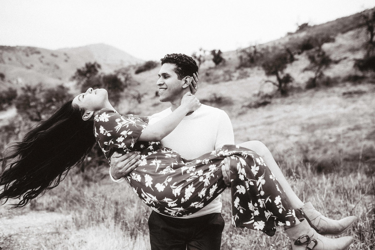 Engagement Photograph Of  Woman Smiling While Being Carries By a Man Los Angeles