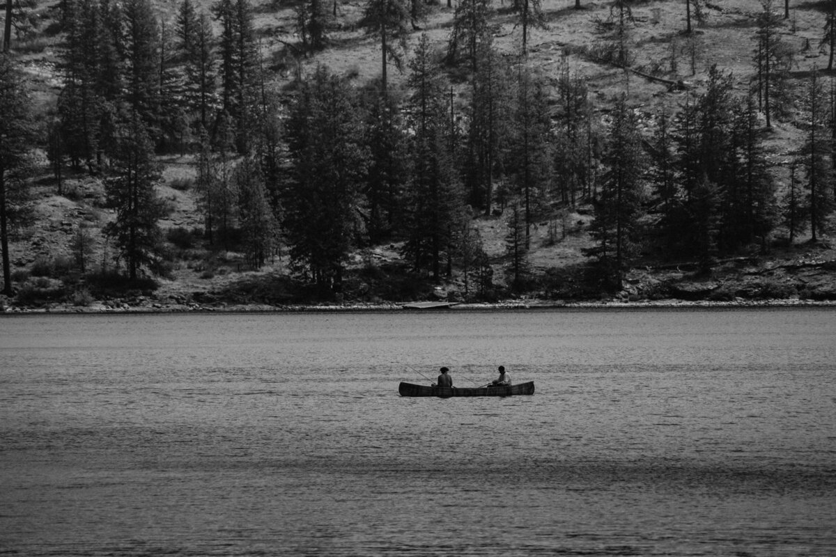A couple shares a quiet moment on the water during their lakeside engagement session in Washington, capturing serenity and connection.