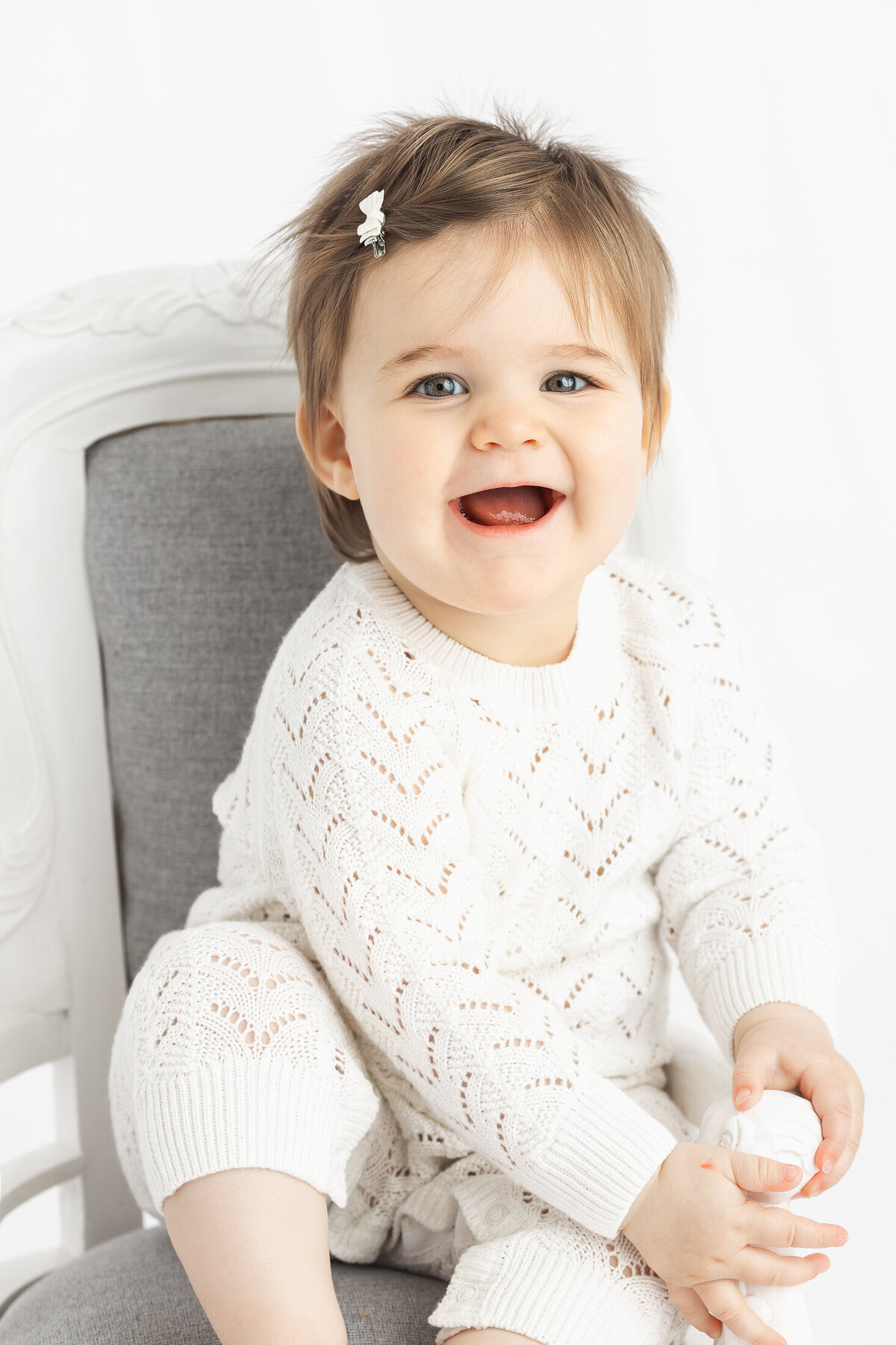 Baby smiling during cakesmash photoshoot by hobart photographer Lauren Vanier Photography
