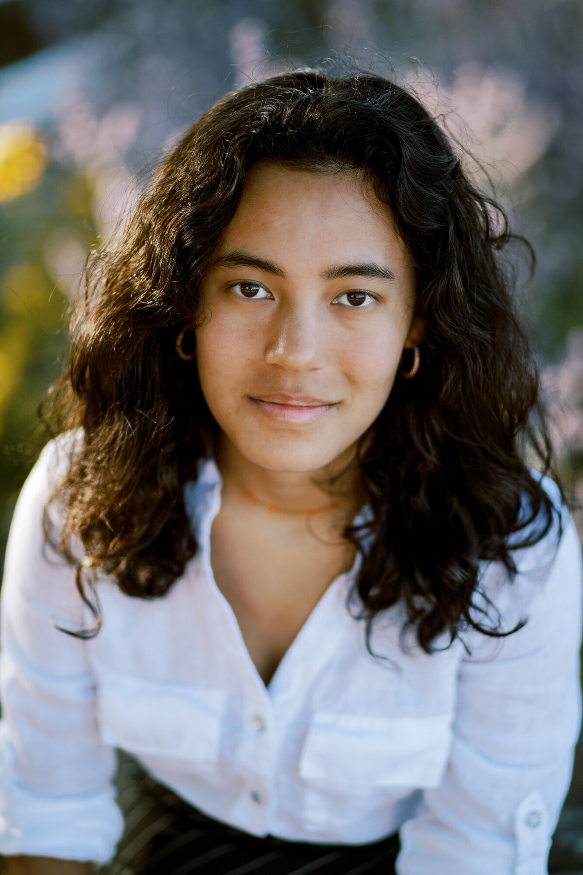 high school senior softly smiles at camera