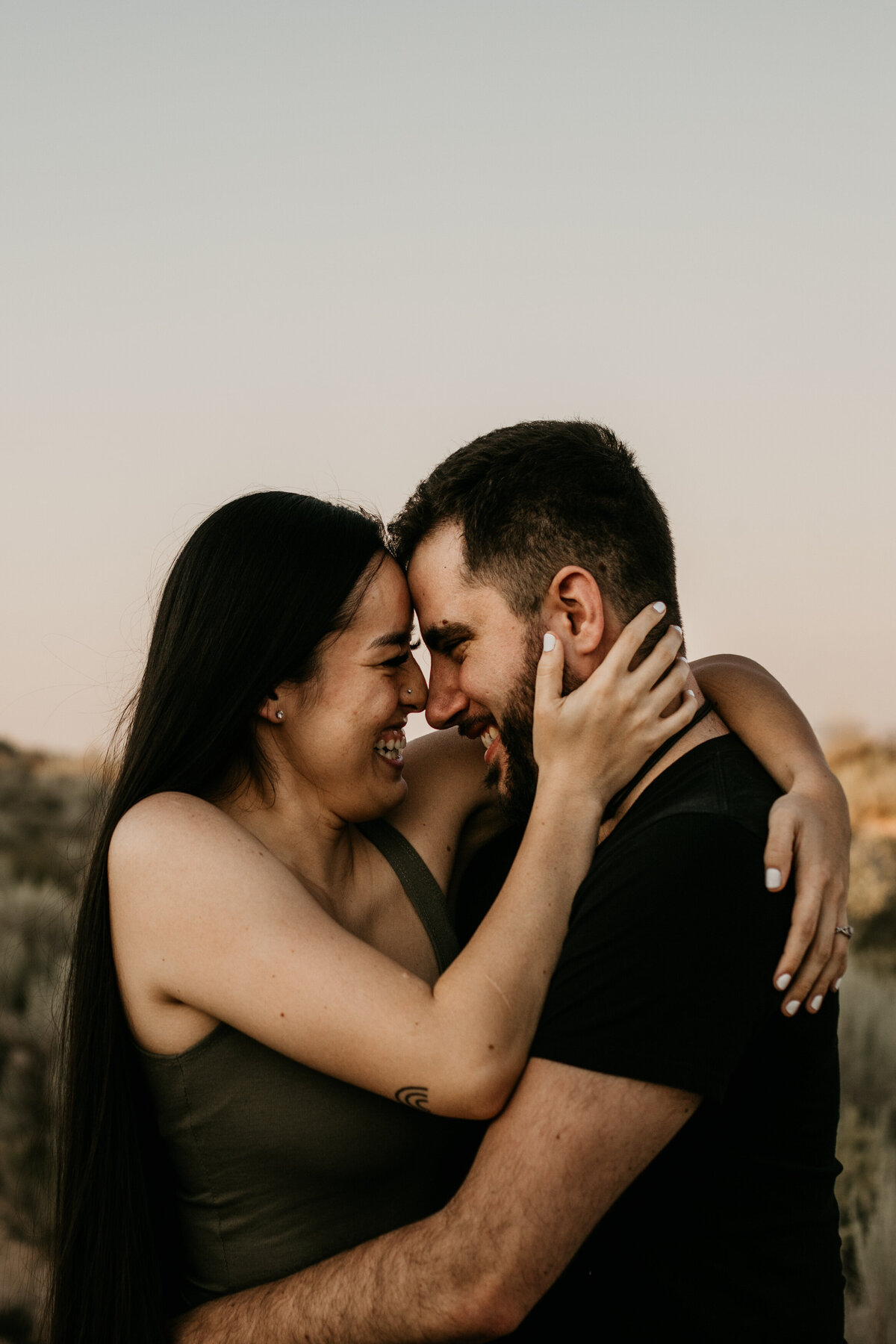 couple holding each other and laughing