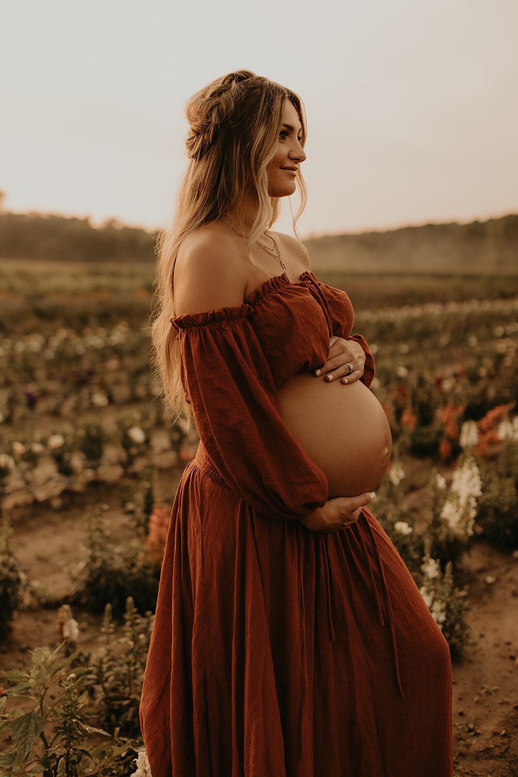 Sunset maternity photography in a flower field