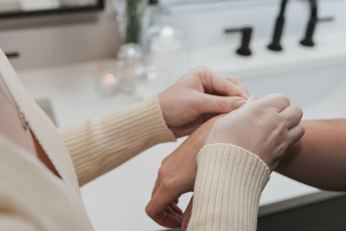Wife puts a bracelet on her new wife