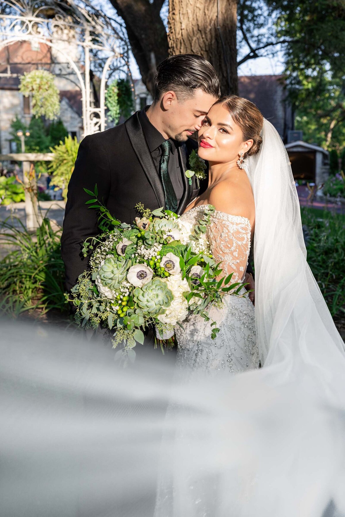 groom-nuzzling-bride-golden-hour-wedding