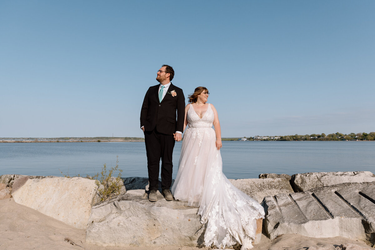 Elopement couple standing on rocks at Headlands Beach State Park.