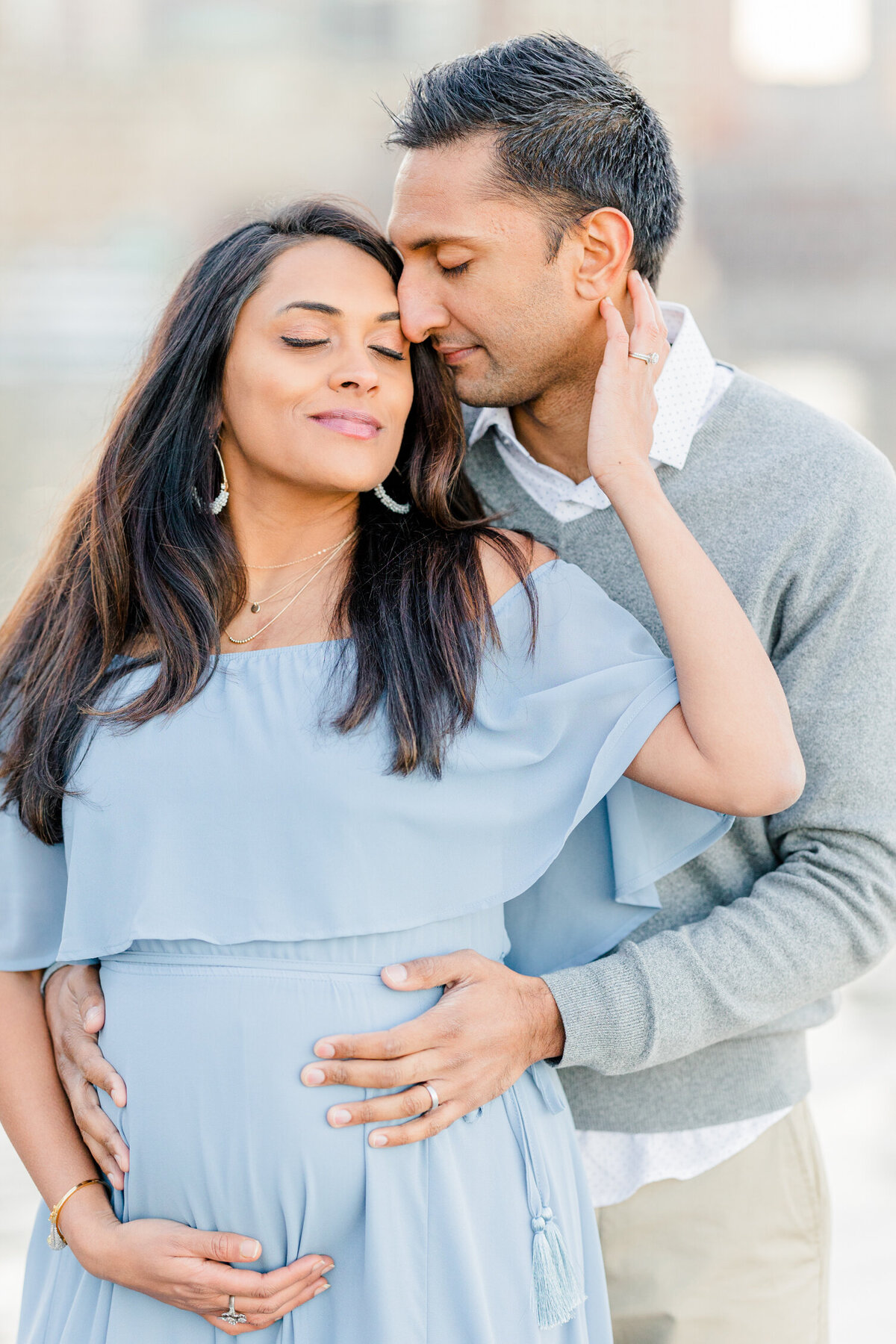 Pregnant woman and husband share moment at Boston Seaport