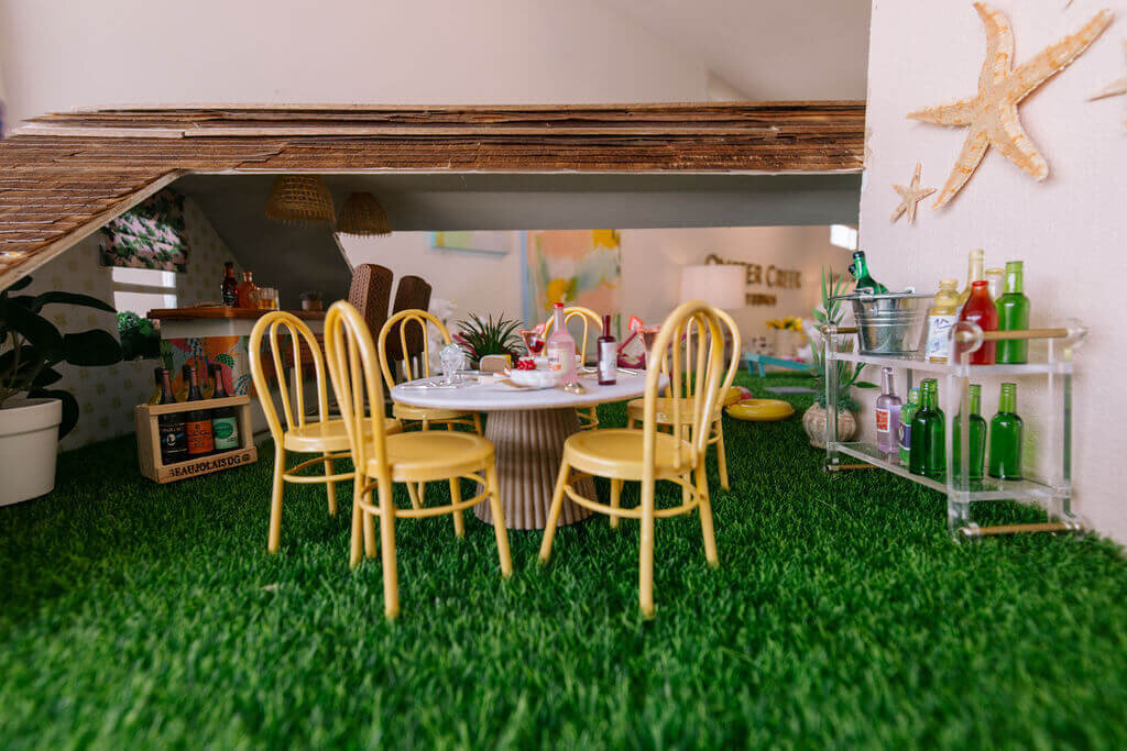 oyster creek studios petite palm beach dollhouse yellow chairs around a white dining room table and turf floor