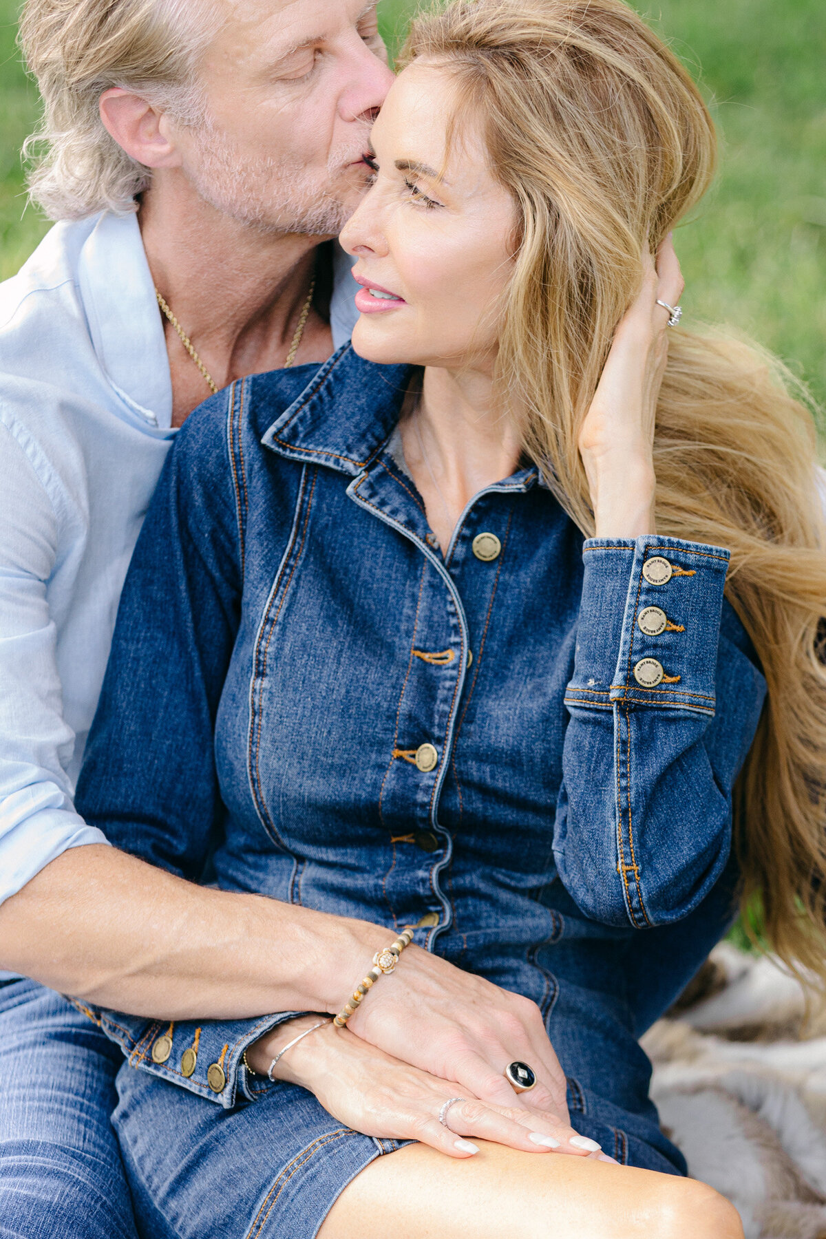 Close-up of an engaged couple at Lakeside Park in Highland Park, she kissing her partner on the forehead