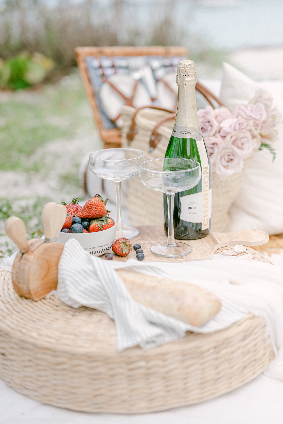 Flowers and champagne, strawberries, cheese and baguette