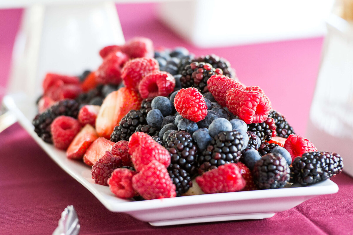 Ottawa event photography showing a tray of berries as part of the snacks being served for a corporate anniversary celebration.  Captured by JEMMAN Photography COMMERCIAL