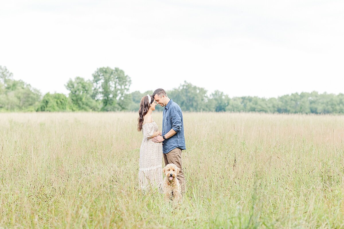 parents and dog during maternity photo session at heard farm in Wayland Massachusetts with Sara Sniderman Photography