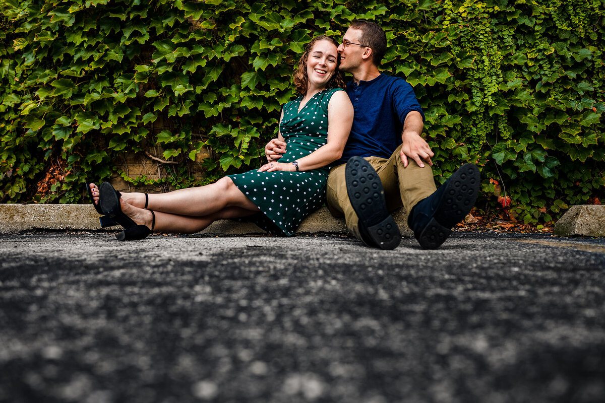 A couple laughs together during a West Loop engagement session.