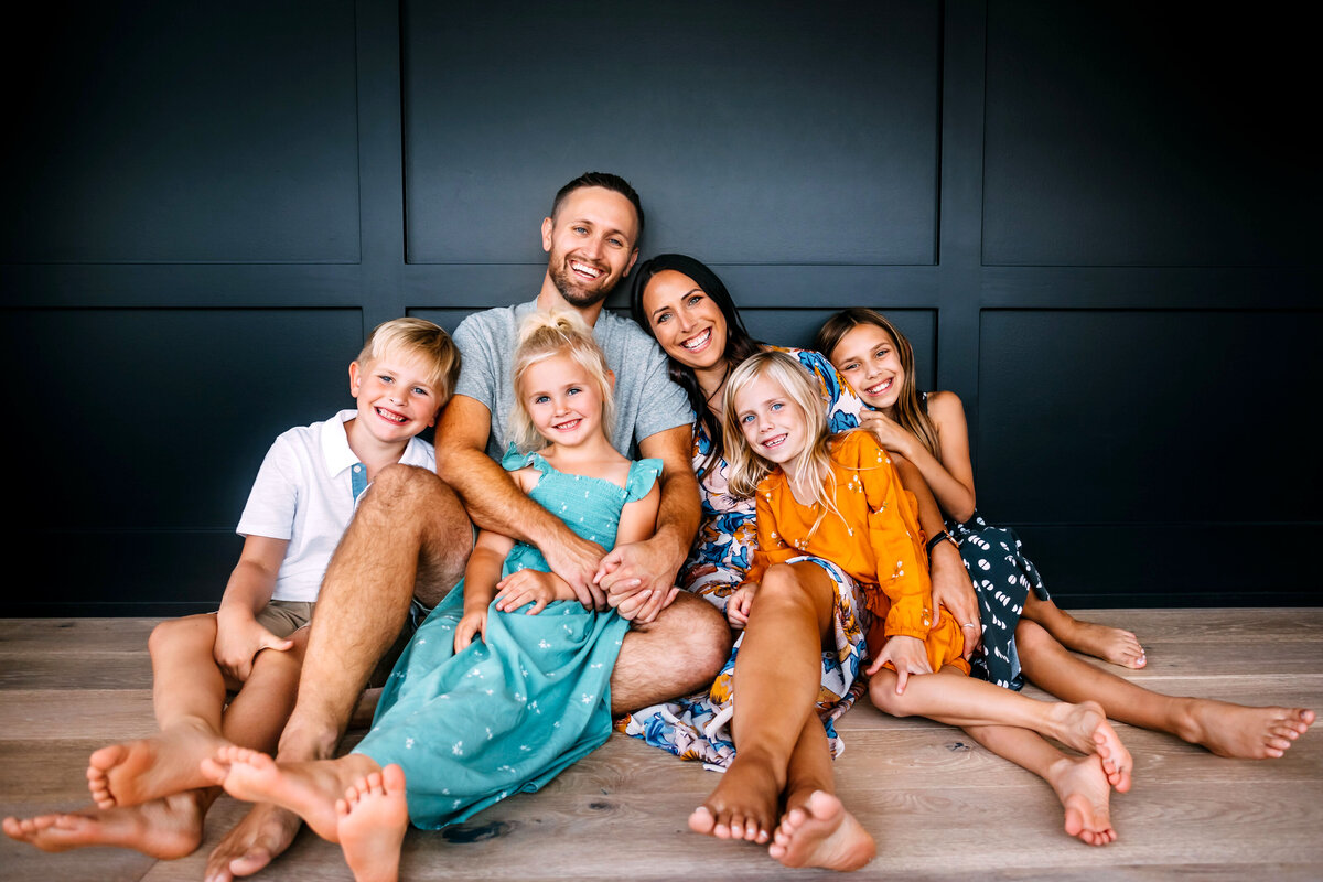 family sitting on floor smiling