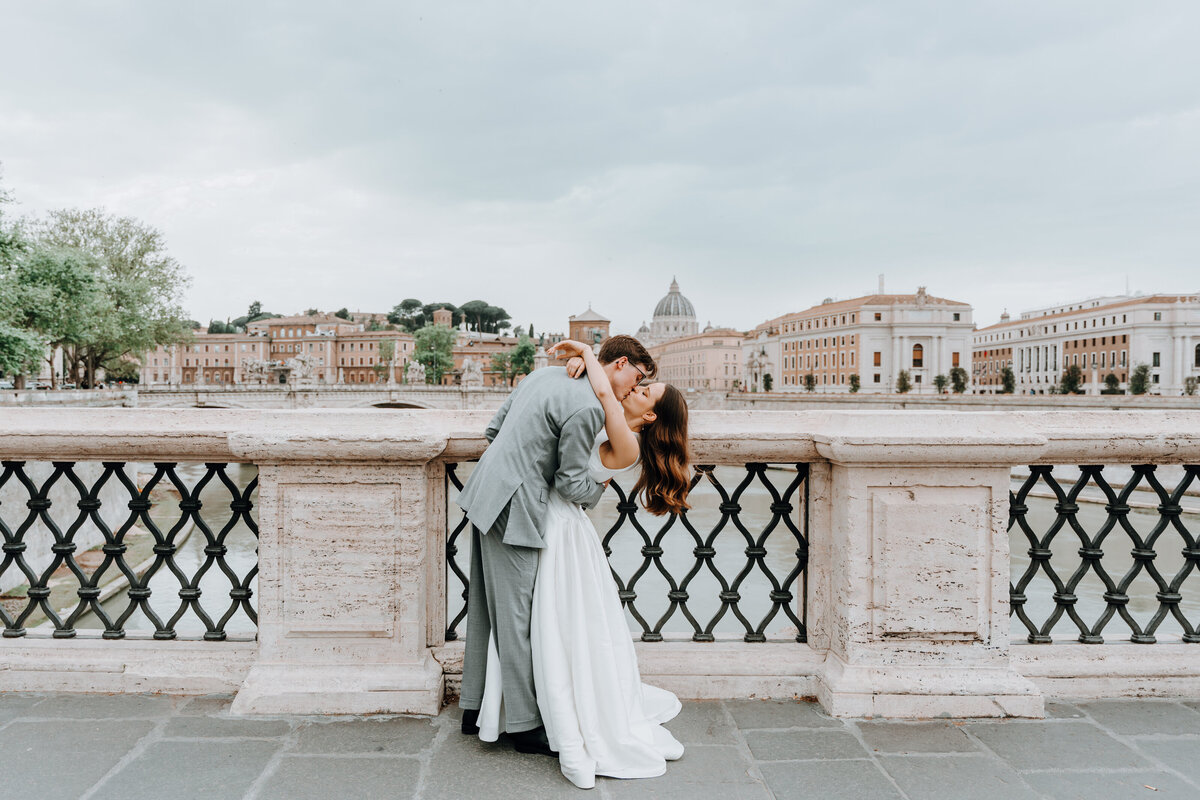 Couple hugging each other on Roman bridge.