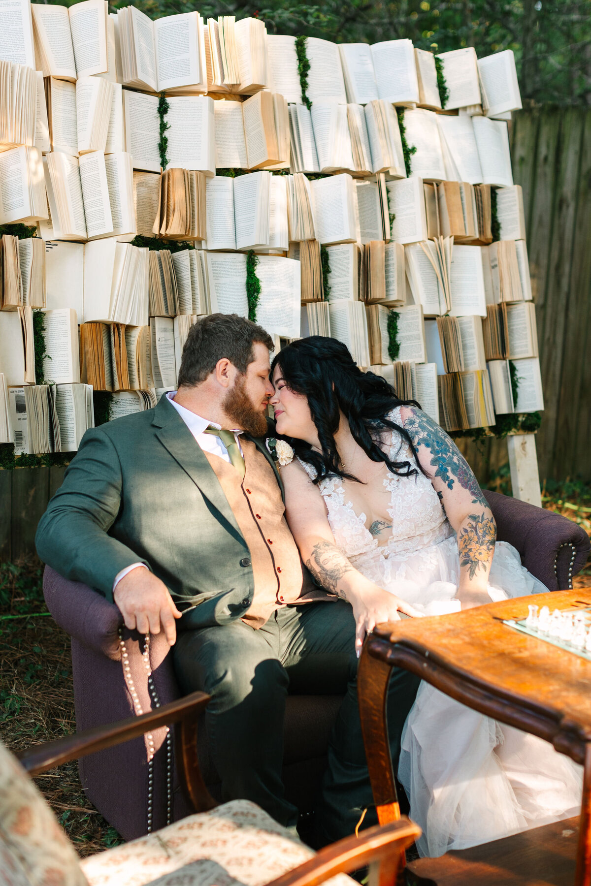 Wedding book wall backdrop behind the bride and groom as they share an intimate moment during their first look