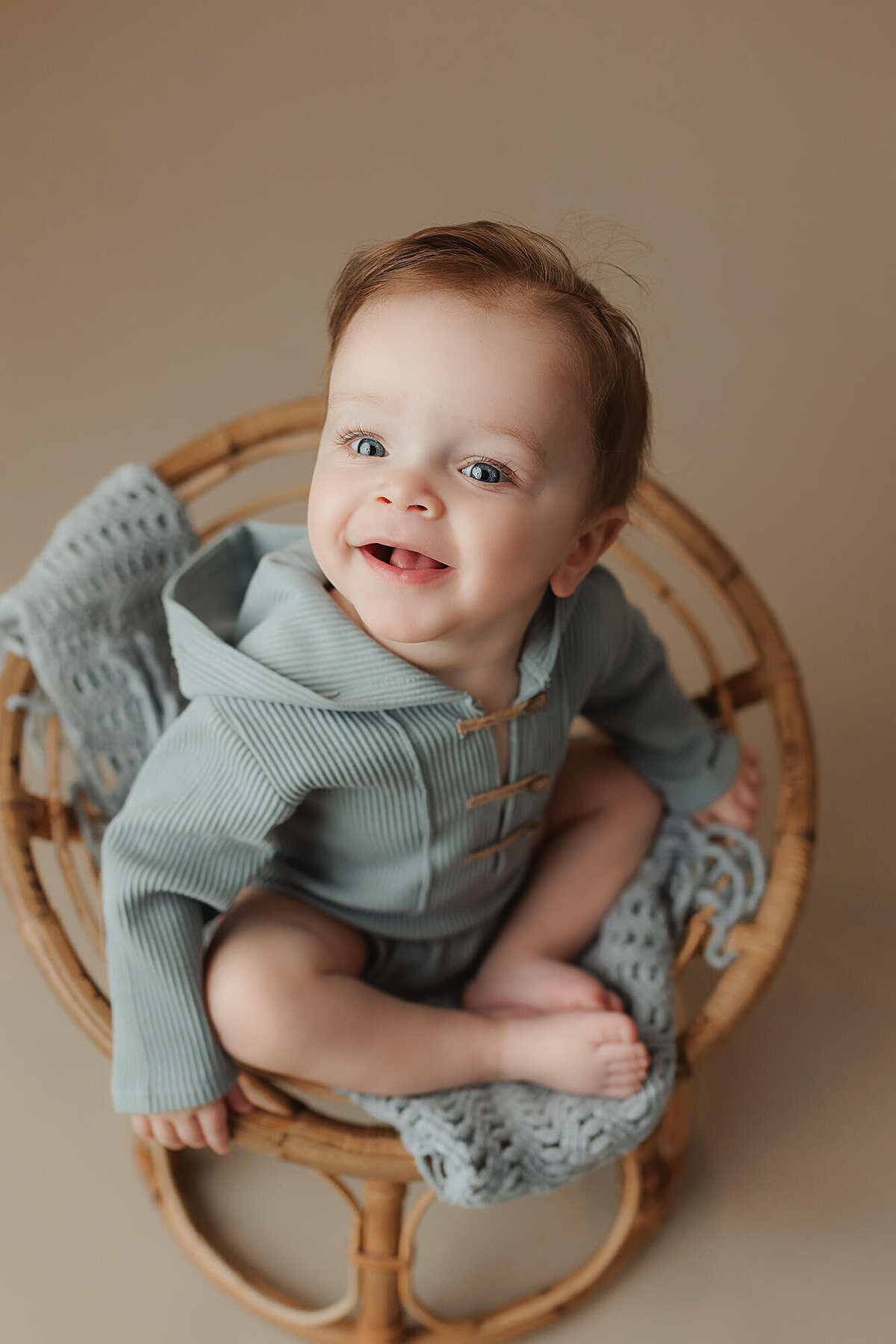 Baby boy smiles during his milestone baby session in Mankato, Minnesota.