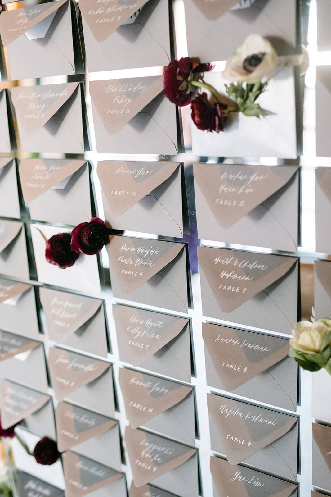 Close-up of a wedding escort board on a mirror at St. Regis Aspen, showcasing elegant calligraphy and refined details