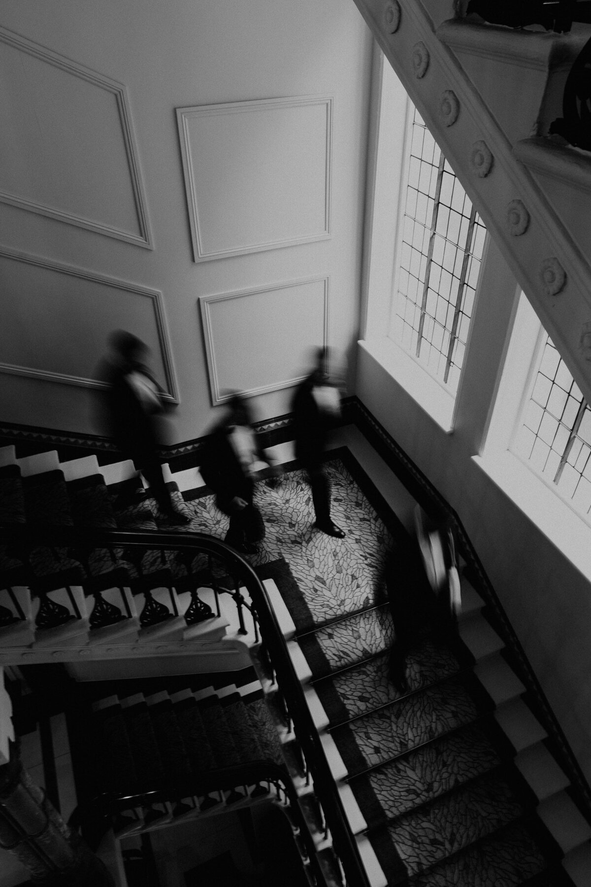 Groom and best men walk down the stairs at Grand Hotel in Birmingham. 