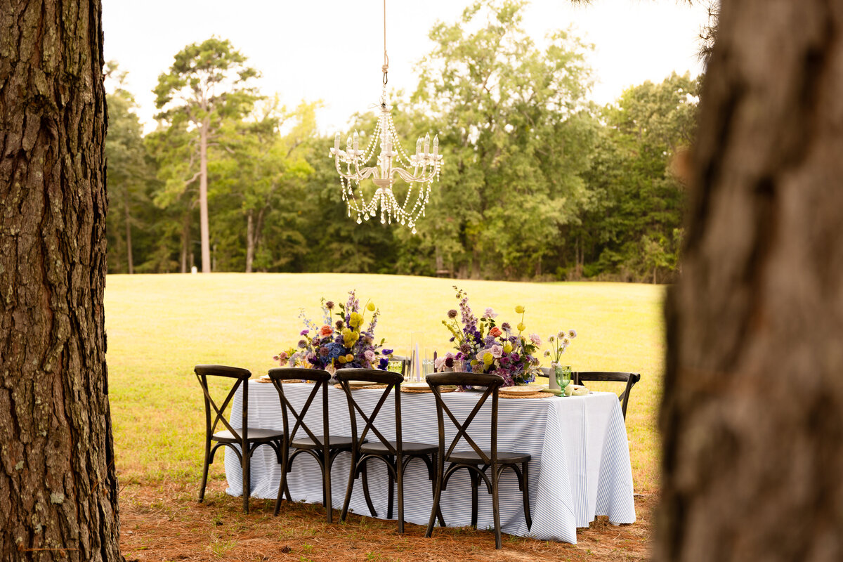 Rehearsal dinner outside in the woods with beautiful spring flowers and a gourmet dinner.